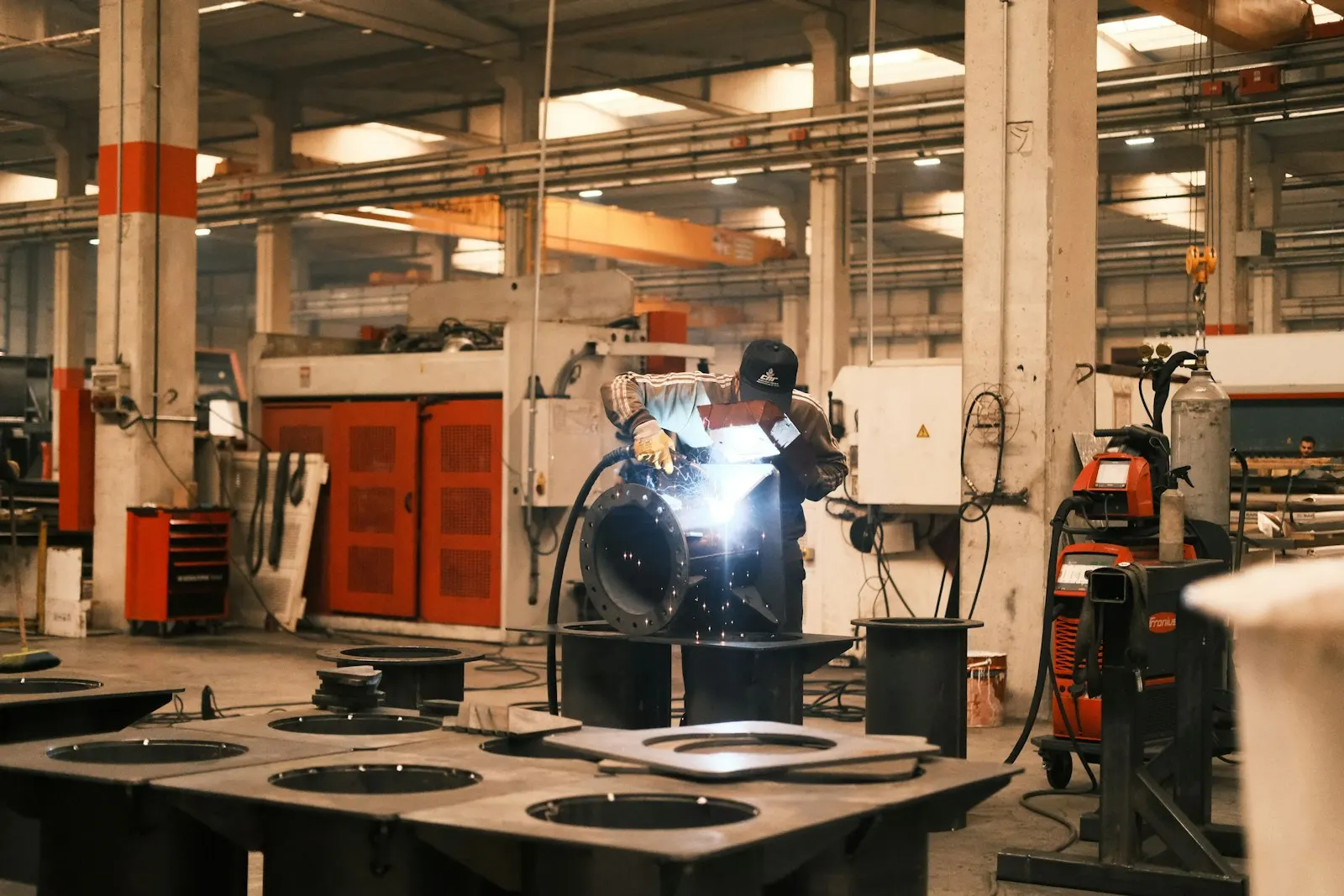Fabricator welding components at the Narshinga Industries manufacturing facility